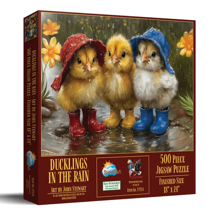 Jigsaw puzzle box featuring three cartoon chicks in raincoats and boots with a scenic background.
